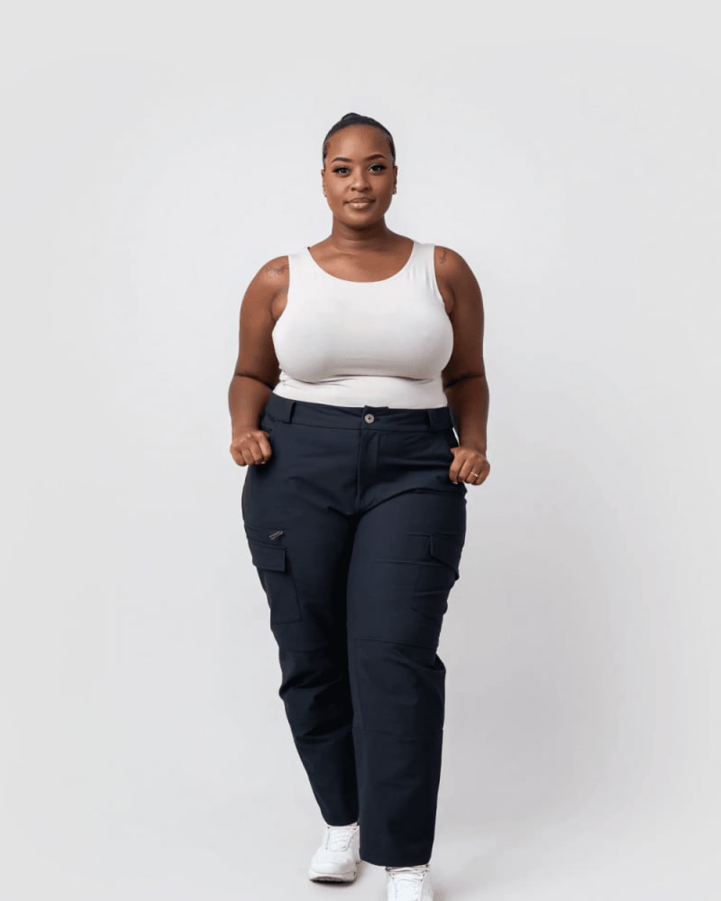 Front of a model wearing a size L take a hike cargo pants in Black by alder apparel. | dia_product_style_image_id:300649